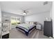 Bedroom with a ceiling fan, bright window, and bed with striped comforter at 684 Se 65Th Ter, Ocala, FL 34472