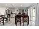Dining area with tile floors, dark wood table with seating for four, and sliding door for natural light at 684 Se 65Th Ter, Ocala, FL 34472