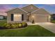 Charming single-Gathering home with a manicured lawn, neat flowerbeds, and a two-car garage at 684 Se 65Th Ter, Ocala, FL 34472