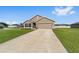 Charming single-Gathering home with a manicured lawn, neat flowerbeds, and a two-car garage at 684 Se 65Th Ter, Ocala, FL 34472