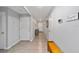 Neutral colored hallway with gray walls, tile flooring, and bench seat at the far end at 684 Se 65Th Ter, Ocala, FL 34472