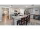 Island kitchen features stainless steel appliances, granite counters, and barstool seating at 684 Se 65Th Ter, Ocala, FL 34472