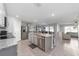 Modern kitchen featuring stainless steel appliances, granite countertops, and an island with seating at 684 Se 65Th Ter, Ocala, FL 34472