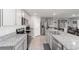 Well-equipped kitchen showcases stainless steel appliances, granite countertops, and white cabinetry at 684 Se 65Th Ter, Ocala, FL 34472