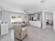 Open living room with tile floors, a ceiling fan, and built-in shelving at 684 Se 65Th Ter, Ocala, FL 34472