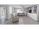 Open living room with tile floors, a ceiling fan, and built-in shelving at 684 Se 65Th Ter, Ocala, FL 34472