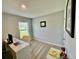 Carpeted home office has a modern desk and a window for plenty of natural light at 684 Se 65Th Ter, Ocala, FL 34472