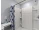 Modern shower with white tile, built in shelving, and rainfall shower head at 684 Se 65Th Ter, Ocala, FL 34472