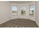 Bright bedroom featuring three large windows and neutral carpeting at 4412 Sw 84Th Street Rd, Ocala, FL 34476