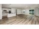 Bright, open-concept living room with a modern kitchen, sleek stainless-steel appliances, and sliding glass doors at 4412 Sw 84Th Street Rd, Ocala, FL 34476