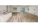 Living room featuring an open layout with kitchen, stainless steel appliances, and sliding door to backyard at 4412 Sw 84Th Street Rd, Ocala, FL 34476