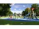 Community playground featuring swings, slides, and play structures amid lush green landscaping at 4412 Sw 84Th Street Rd, Ocala, FL 34476