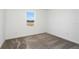 Well-lit bedroom with neutral carpeting and a window at 4397 Sw 84Th Street Rd, Ocala, FL 34476