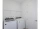 Laundry room with washer, dryer, and shelving at 4424 Sw 84Th Street Rd, Ocala, FL 34476