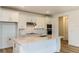 Modern kitchen featuring white cabinets, stainless steel appliances, and a center island with quartz countertops at 4457 Sw 84Th Street Rd, Ocala, FL 34476