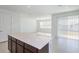 Kitchen island with white countertop offering extra workspace and seating at 4416 Sw 84Th Street Rd, Ocala, FL 34476