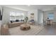 Bright living room featuring a neutral palette, stylish furnishings, and ample natural light from a large window at 4416 Sw 84Th Street Rd, Ocala, FL 34476