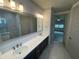 Double vanity bathroom with a large mirror and modern lighting at 7987 Lake James Blvd, Lakeland, FL 33810