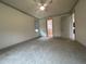 Bedroom with access to the bathroom and a large window at 7987 Lake James Blvd, Lakeland, FL 33810