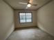 Well-lit bedroom with ceiling fan and carpet flooring at 7987 Lake James Blvd, Lakeland, FL 33810