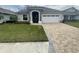 One-story home with a two-car garage, and landscaped lawn at 7987 Lake James Blvd, Lakeland, FL 33810