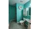 Teal bathroom with white vanity and tiled floor at 9930 Se 67Th Avenue Rd, Belleview, FL 34420