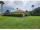 House with lush landscaping and a pool in the background at 9930 Se 67Th Avenue Rd, Belleview, FL 34420