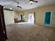 Open living room with access to a patio and kitchen at 9930 Se 67Th Avenue Rd, Belleview, FL 34420