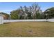 Large fenced backyard with grassy area and mature trees at 2724 Oxford St, Orlando, FL 32803