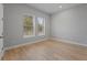 Bright and airy bedroom with light wood flooring and two windows at 2724 Oxford St, Orlando, FL 32803