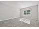 Spacious bedroom with gray carpeting and a window at 2724 Oxford St, Orlando, FL 32803