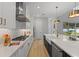 White kitchen with marble countertops and a farmhouse sink at 2724 Oxford St, Orlando, FL 32803