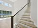 Modern staircase with dark wood railing and light wood steps at 2724 Oxford St, Orlando, FL 32803