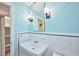 Clean bathroom with white tile, a sink, and a linen closet at 2771 Park Ave, Indian Lake Estates, FL 33855