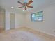 Bright bedroom with tile floors and ceiling fan at 2771 Park Ave, Indian Lake Estates, FL 33855