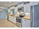 Beautiful kitchen with stainless steel appliances, white cabinets, and stylish butcher block countertops at 2771 Park Ave, Indian Lake Estates, FL 33855