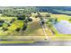 Aerial view of property with home, land, pond, and highway access at 705 Sr 50, Webster, FL 33597