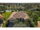 Single-story house with tile roof, screened lanai, and backyard at 738 Volterra Blvd, Kissimmee, FL 34759