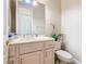 Clean bathroom with single sink vanity, toilet and light colored cabinets at 738 Volterra Blvd, Kissimmee, FL 34759