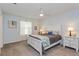 Cozy bedroom with a white bed frame, light blue walls, and a ceiling fan for added comfort at 3445 Roanoke St, The Villages, FL 32162