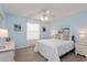 Comfortable bedroom featuring light blue walls, carpet, and a cozy bed with decorative pillows at 3445 Roanoke St, The Villages, FL 32162