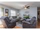 Comfortable living room with a ceiling fan, plush seating, a TV, and natural light from the window at 3445 Roanoke St, The Villages, FL 32162