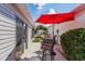 Inviting patio area with an umbrella-covered table set, ideal for outdoor relaxation and dining at 3445 Roanoke St, The Villages, FL 32162