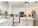 Modern kitchen with white cabinets, quartz countertops, and stainless steel appliances at 323 Nw 25Th St, Ocala, FL 34475