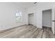 Bedroom featuring wood-look floors, white walls, trim, closet, and bright window at 225 Diesel Rd, Mulberry, FL 33860