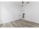 A simple bedroom with hard flooring and a door leading to the kitchen at 225 Diesel Rd, Mulberry, FL 33860