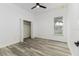A bright bedroom has wood-look floors, a ceiling fan, a window and closet at 225 Diesel Rd, Mulberry, FL 33860