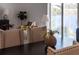 A dining table with a vase of flowers sits next to a living room with a large sofa at 225 Diesel Rd, Mulberry, FL 33860