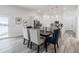 An elegant dining room features an open layout connecting to a modern kitchen with stainless steel appliances at 225 Diesel Rd, Mulberry, FL 33860