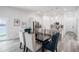 Dining area with views and stylish chairs flows into a well-appointed kitchen with stainless steel appliances at 225 Diesel Rd, Mulberry, FL 33860